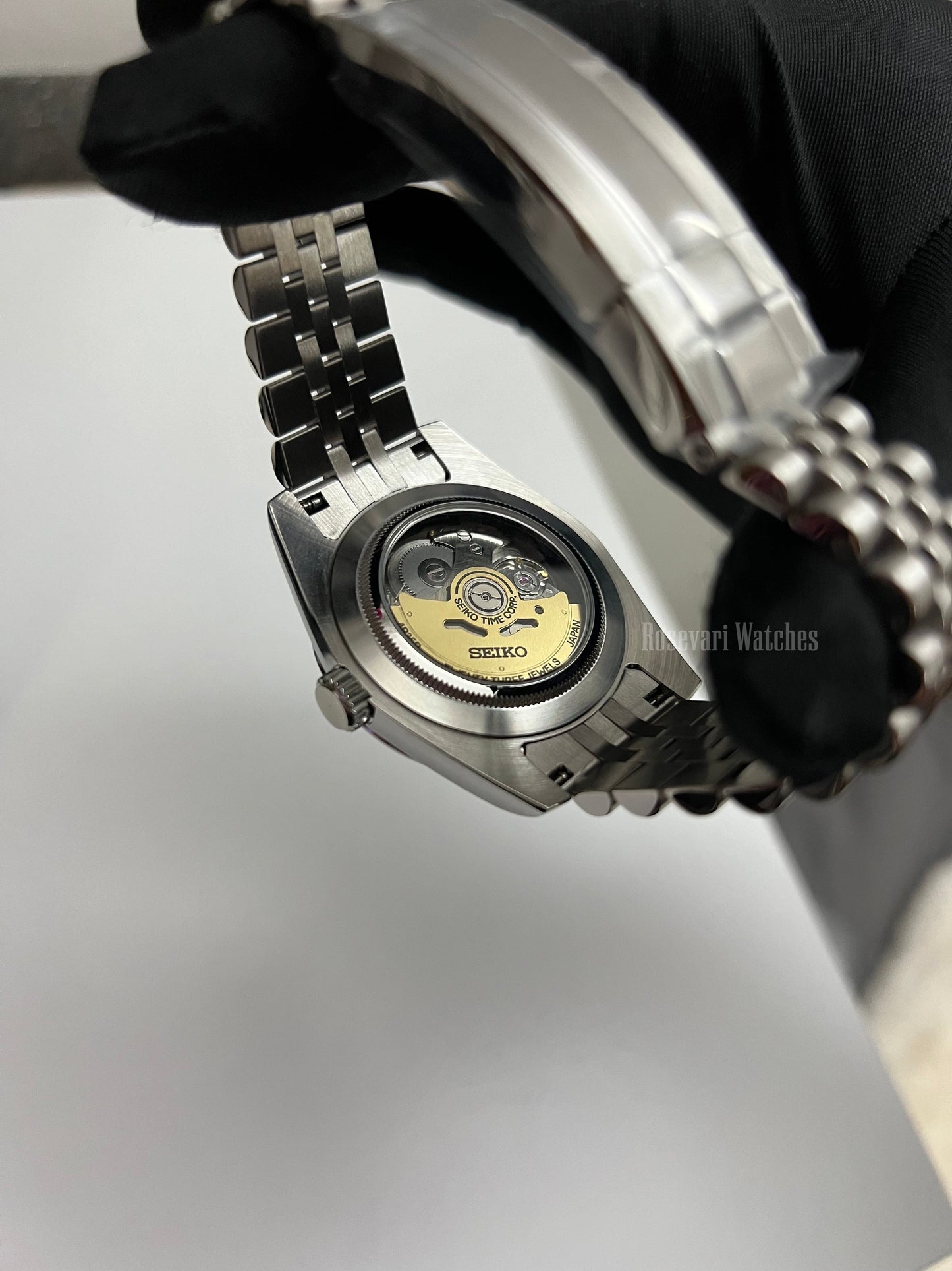 Datejust (Arabic Blue) Seiko NH35 automatic mod watch. A caseback detail shot showing the internal mechanical movement of the watch with a metal link bracelet.