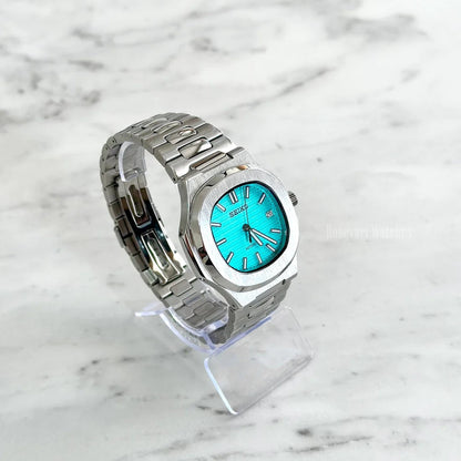 Nautilus (Tiffany Blue) Seiko NH35 automatic mod watch. An angled full watch shot shows a turquoise dial with a silver bezel and a silver metal link bracelet.