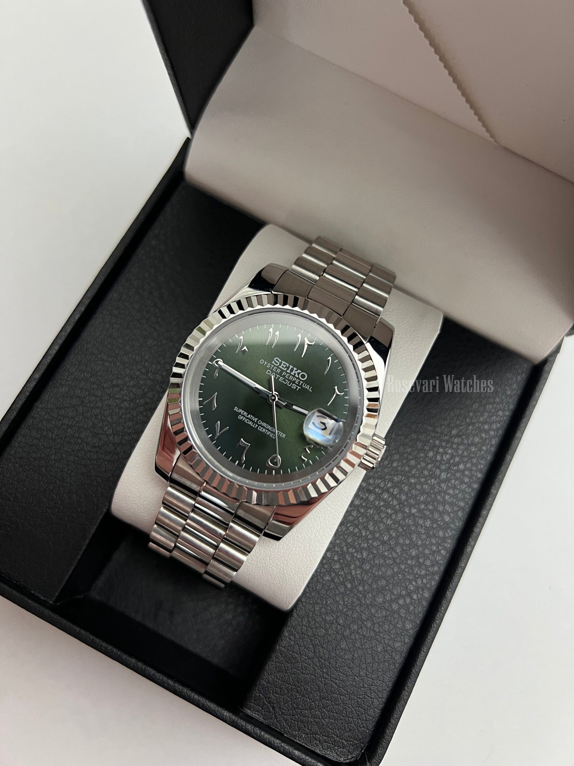 Datejust (Arabic Olive) Seiko NH35 automatic mod watch. A full watch with a green dial and silver fluted bezel on a silver jubilee bracelet inside a box.