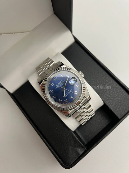 Datejust (Arabic Royal Blue) Seiko NH35 automatic mod watch. A blue dial watch with a silver fluted bezel and jubilee bracelet inside an open watch box.