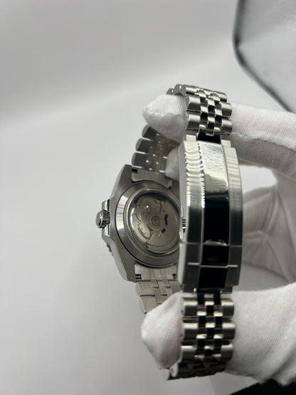 GMT (Pepsi) Seiko NH34 GMT automatic mod watch. A caseback and clasp detail shows the back of a watch case and a silver metal bracelet clasp.